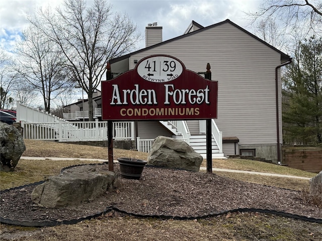 community / neighborhood sign with fence