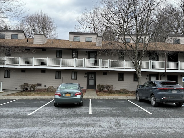 view of property with uncovered parking