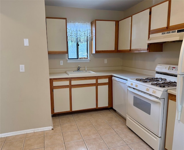 kitchen featuring under cabinet range hood, a sink, white appliances, light countertops, and light tile patterned floors