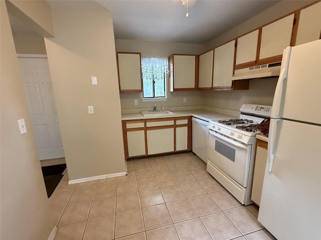 kitchen with white appliances, light tile patterned floors, a sink, light countertops, and under cabinet range hood