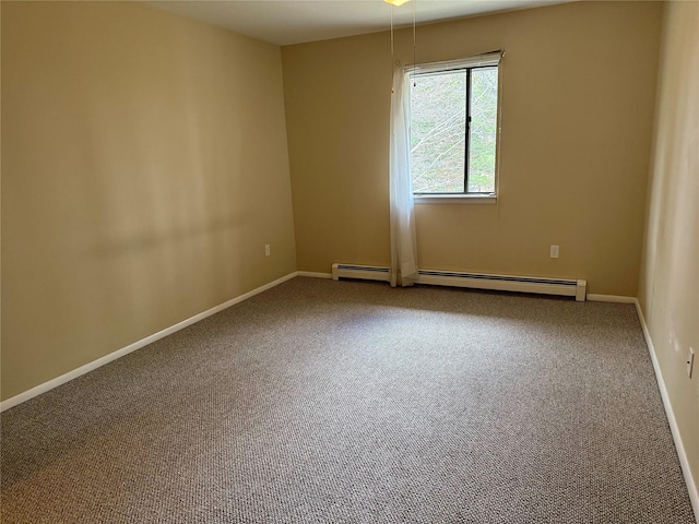 empty room with a baseboard radiator, baseboards, and carpet flooring