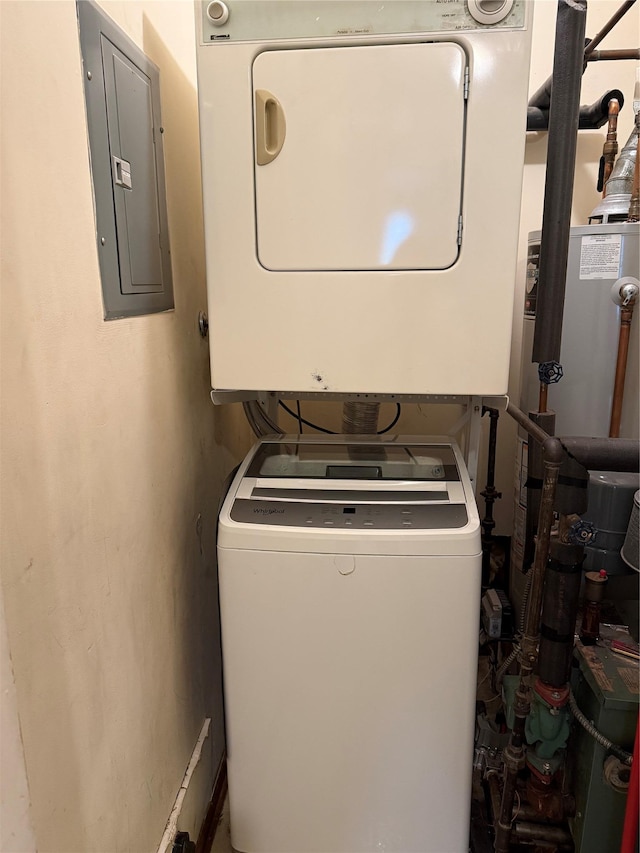 laundry area featuring laundry area, electric panel, and stacked washer / drying machine