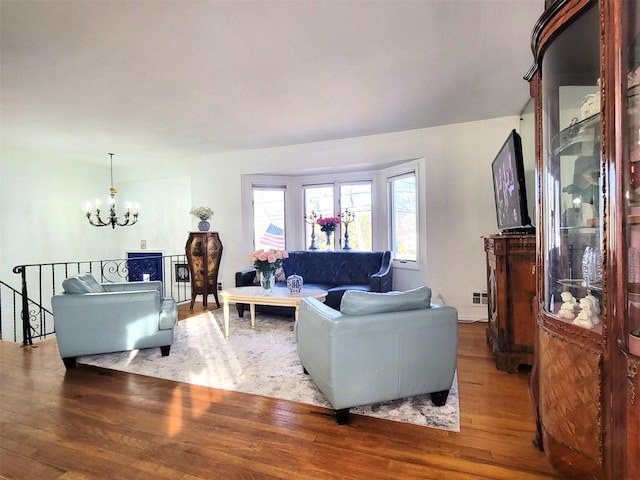 living room with a chandelier and wood finished floors