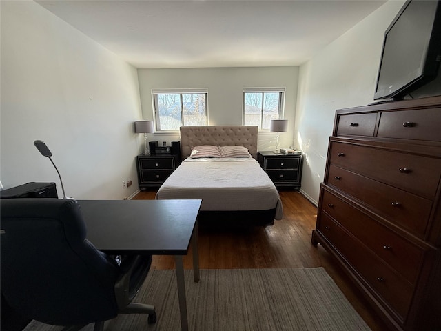 bedroom featuring dark wood-type flooring and baseboards