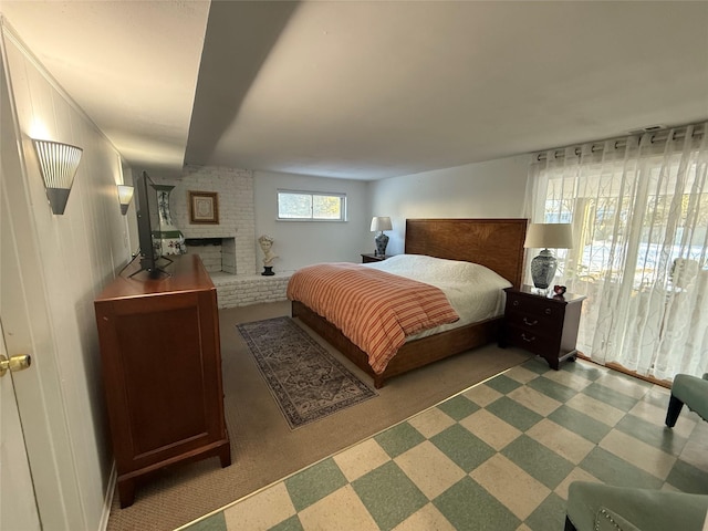 bedroom featuring a fireplace and tile patterned floors