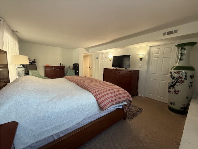 carpeted bedroom featuring visible vents