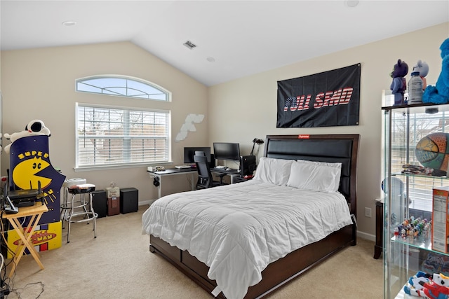 carpeted bedroom featuring lofted ceiling and visible vents