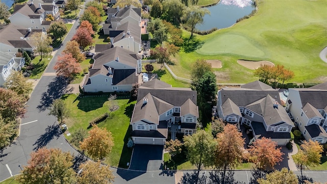 aerial view featuring a water view, view of golf course, and a residential view