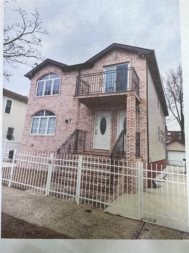 153-33 119th Rd, Jamaica, NY 11434 - view of front of house with a balcony, brick siding, and a fenced front yard