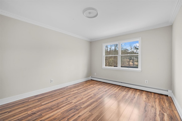 unfurnished room featuring a baseboard heating unit, baseboards, wood finished floors, and ornamental molding