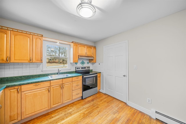 kitchen featuring a baseboard radiator, electric range, a sink, under cabinet range hood, and tasteful backsplash