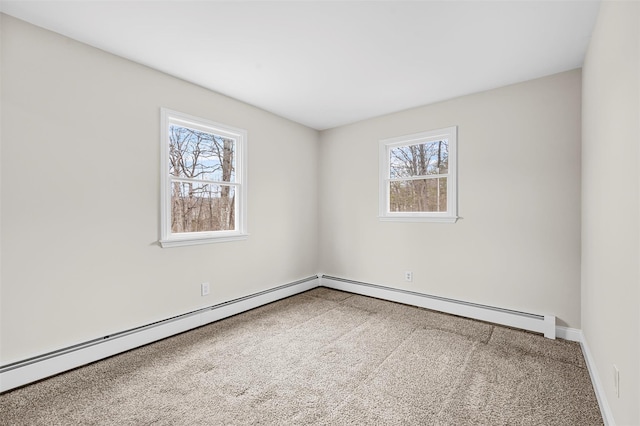 carpeted spare room featuring baseboard heating and baseboards