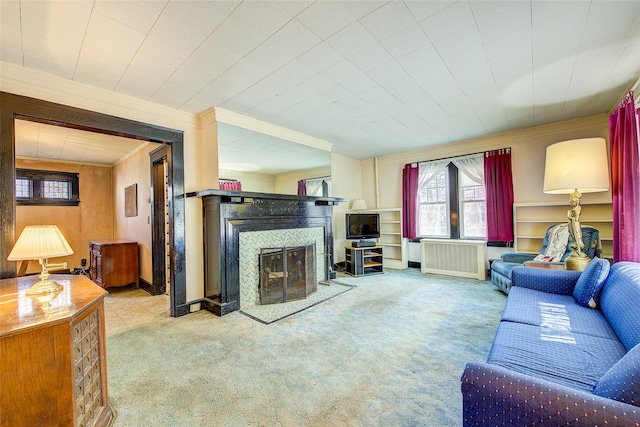 living room featuring carpet flooring, ornamental molding, radiator heating unit, and a glass covered fireplace