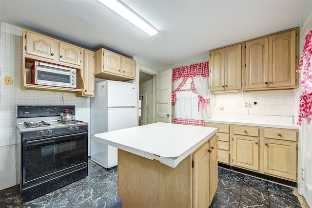 kitchen featuring black gas range oven, marble finish floor, freestanding refrigerator, and light brown cabinetry