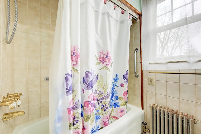 bathroom featuring shower / bath combo and radiator heating unit