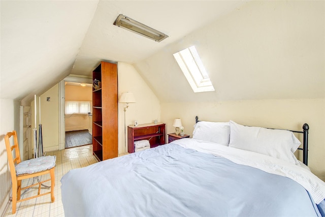 bedroom featuring vaulted ceiling with skylight