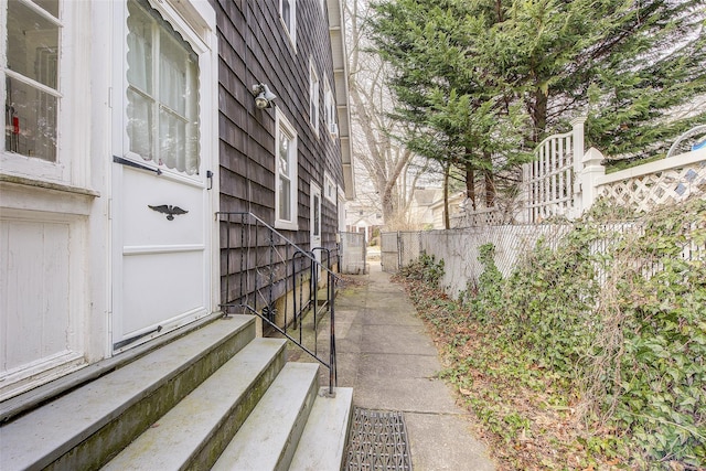 exterior space featuring entry steps and fence