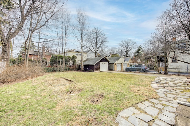 view of yard with a garage and fence