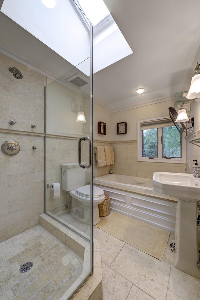 full bath featuring a garden tub, a shower stall, tile walls, and crown molding