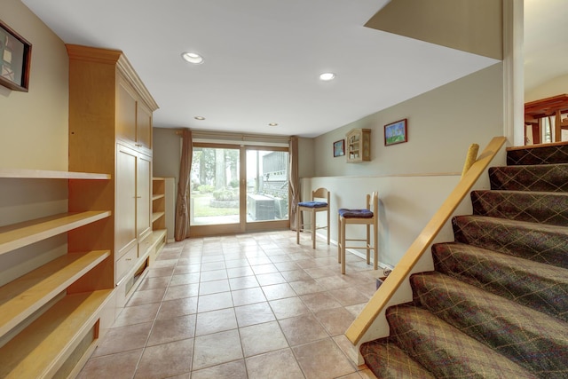 interior space with light tile patterned floors, stairway, and recessed lighting