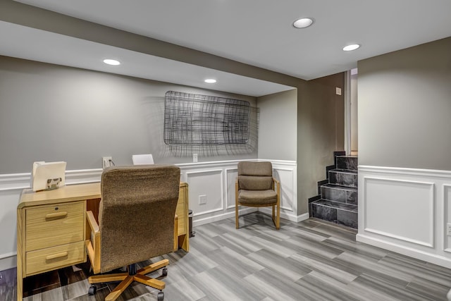 home office featuring a decorative wall, wainscoting, wood finished floors, and recessed lighting