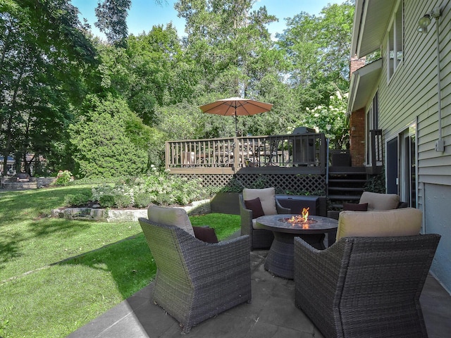 view of patio / terrace featuring a fire pit and a wooden deck