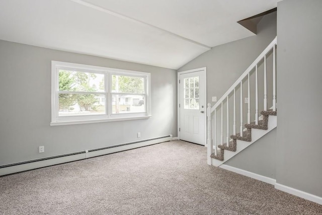 interior space with lofted ceiling, baseboards, stairs, and a baseboard heating unit