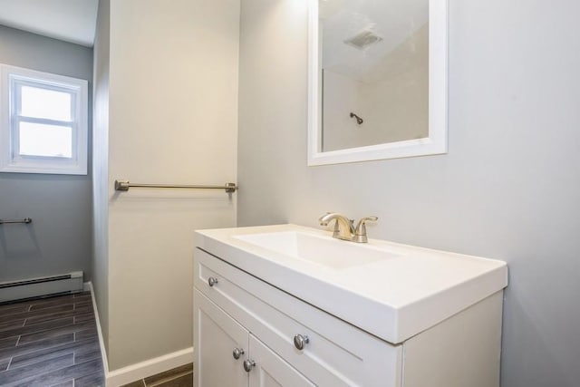 8 Fleet Rd, Shirley, NY 11967 - bathroom featuring wood finish floors, a baseboard radiator, visible vents, vanity, and baseboards