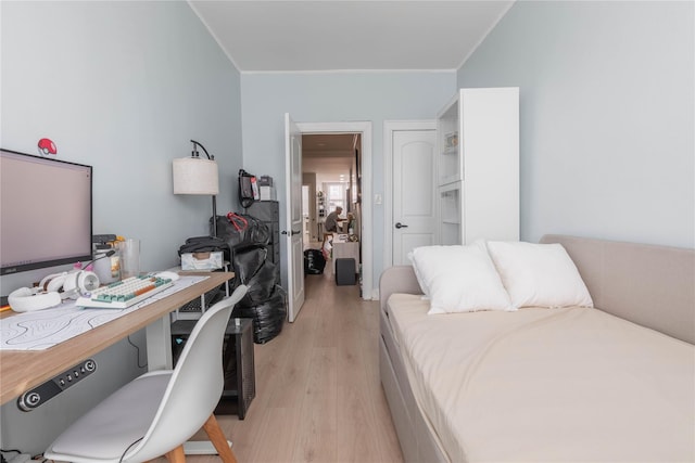 interior space with light wood finished floors and ornamental molding