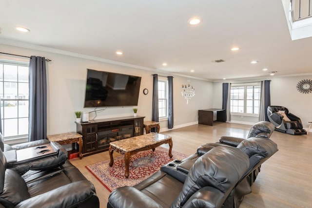 living area with ornamental molding, recessed lighting, visible vents, and light wood-style floors