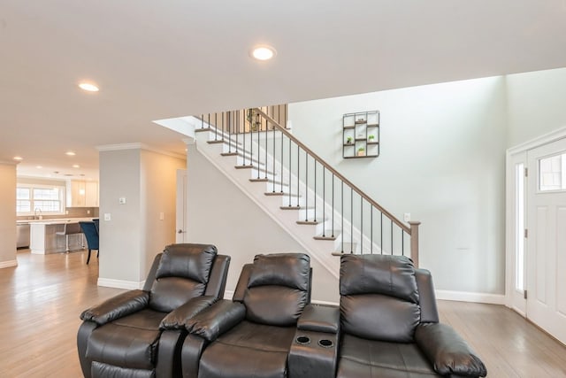 foyer entrance with recessed lighting, baseboards, stairway, and light wood finished floors