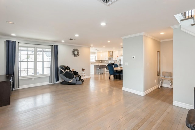 interior space with baseboards, visible vents, ornamental molding, light wood-style floors, and recessed lighting