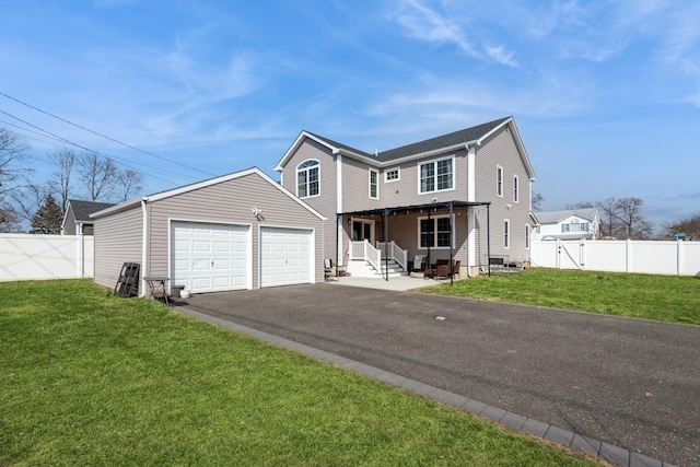 view of front of home with driveway, a front lawn, and fence private yard