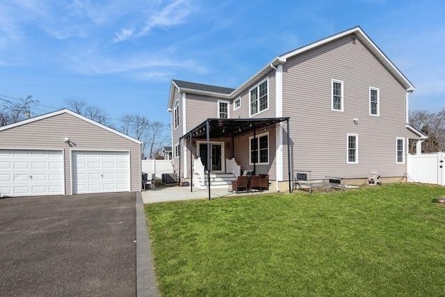 exterior space featuring entry steps, fence, a garage, an outdoor structure, and a front lawn