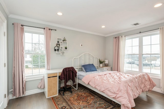 bedroom featuring recessed lighting, visible vents, wood finished floors, and ornamental molding