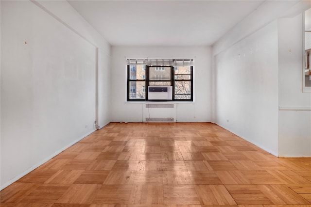 unfurnished room featuring radiator