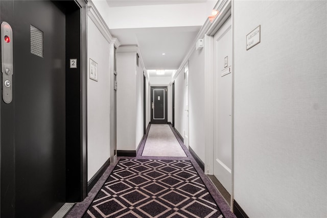 corridor with baseboards and elevator