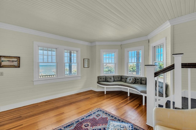 sitting room with wooden ceiling, wood finished floors, baseboards, and ornamental molding