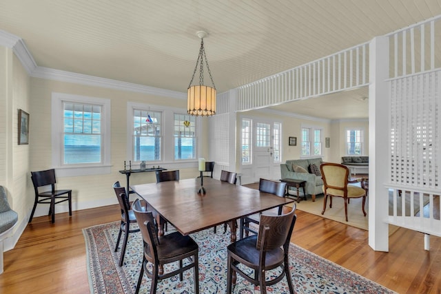 dining room featuring ornamental molding and wood finished floors