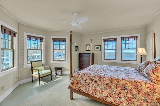 bedroom featuring ceiling fan, multiple windows, baseboards, and ornamental molding