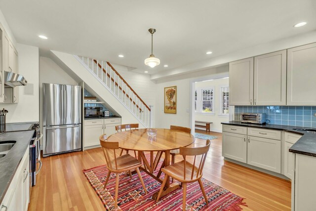 140 Newtown Rd, Hampton Bays, NY 11946 - dining room with stairs, a toaster, recessed lighting, and light wood finished floors