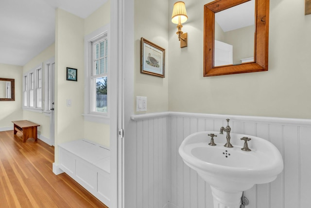 140 Newtown Rd, Hampton Bays, NY 11946 - bathroom featuring wood finished floors and a wainscoted wall