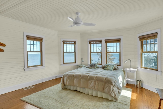 140 Newtown Rd, Hampton Bays, NY 11946 - bedroom with visible vents, multiple windows, and wood finished floors