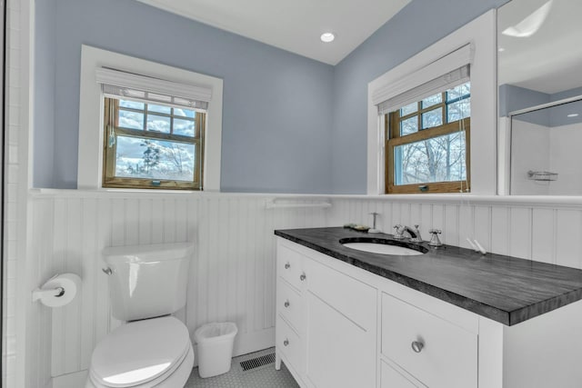 140 Newtown Rd, Hampton Bays, NY 11946 - full bath featuring visible vents, toilet, wainscoting, an enclosed shower, and vanity