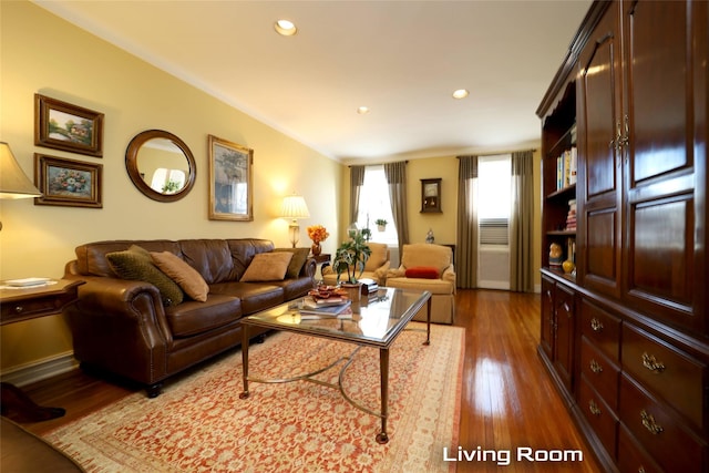 living area with recessed lighting and wood finished floors