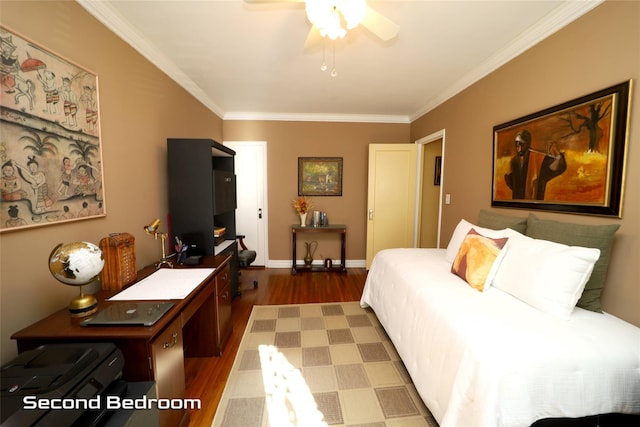 bedroom featuring ornamental molding, wood finished floors, a ceiling fan, and baseboards