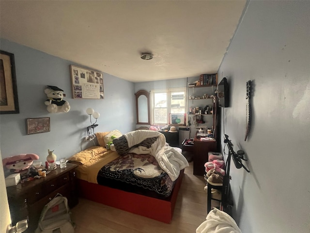 bedroom featuring wood finished floors