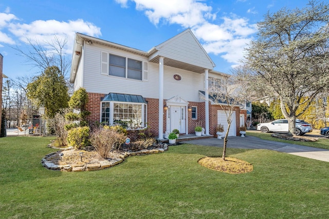 view of front of property featuring driveway, brick siding, and a front lawn