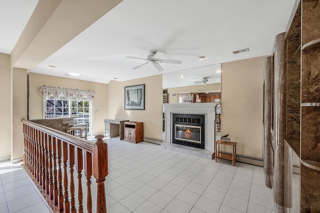 tiled living area featuring visible vents, baseboard heating, and a high end fireplace