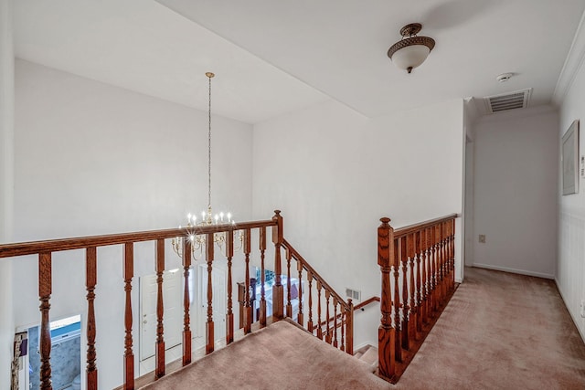 staircase with carpet floors, an inviting chandelier, and visible vents